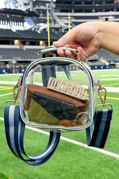 clear crossbody bag with blue two toned purse strap at AT&T stadium